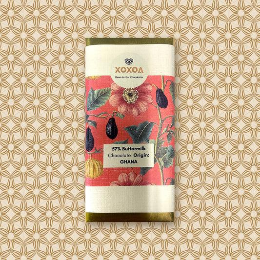 Ghana 57% buttermilk chocolate bar, 42g, in the coral botanical Xoxoa sleeve over gold foil