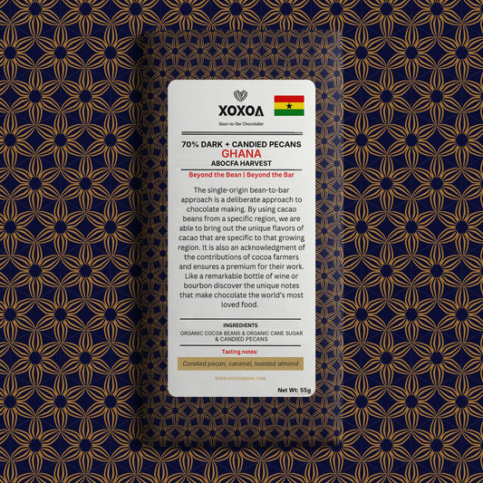 Ghana 70% dark chocolate bar with candied pecans in the navy and gold Xoxoa wrapper