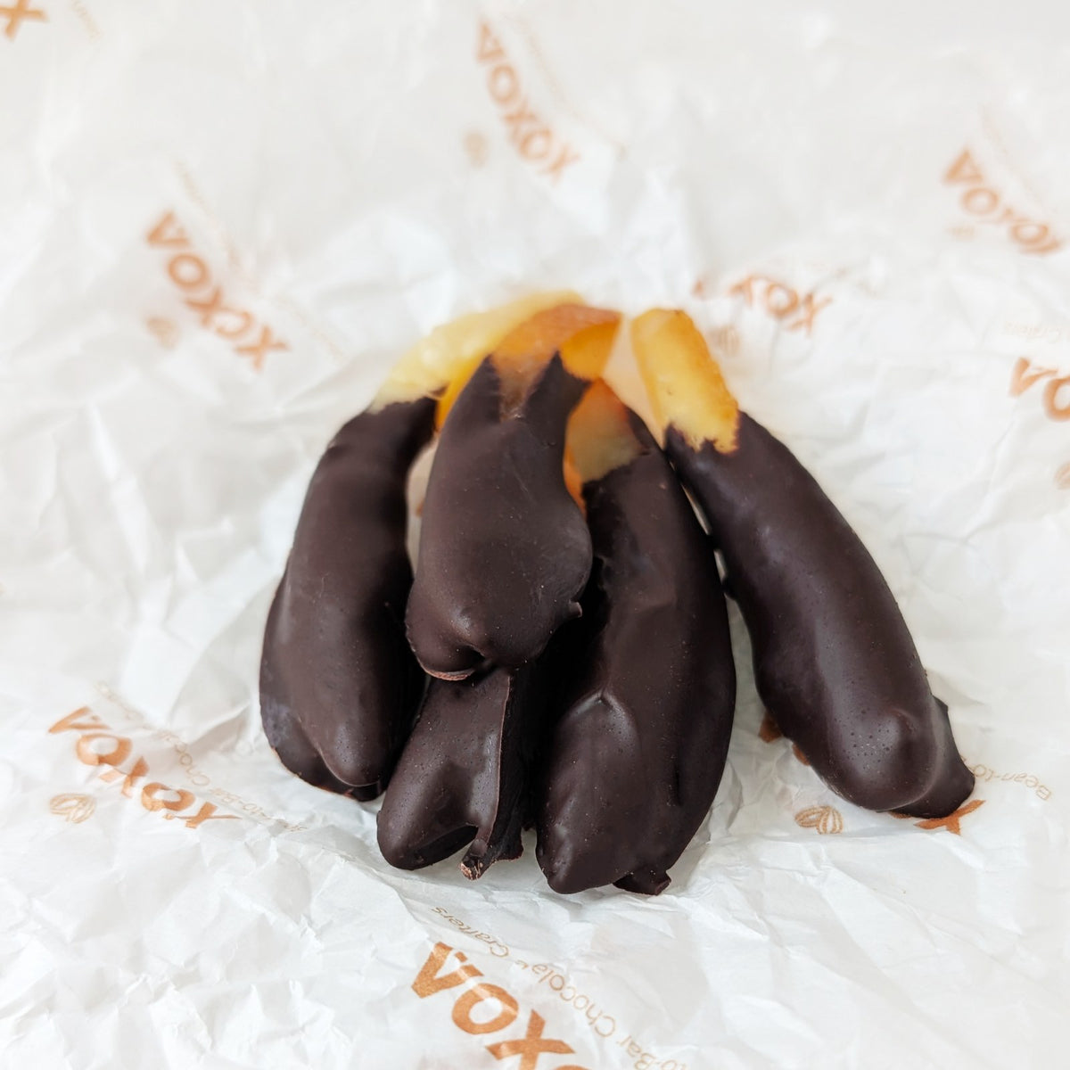 Sussade chocolate-dipped orange peel on Xoxoa printed tissue paper